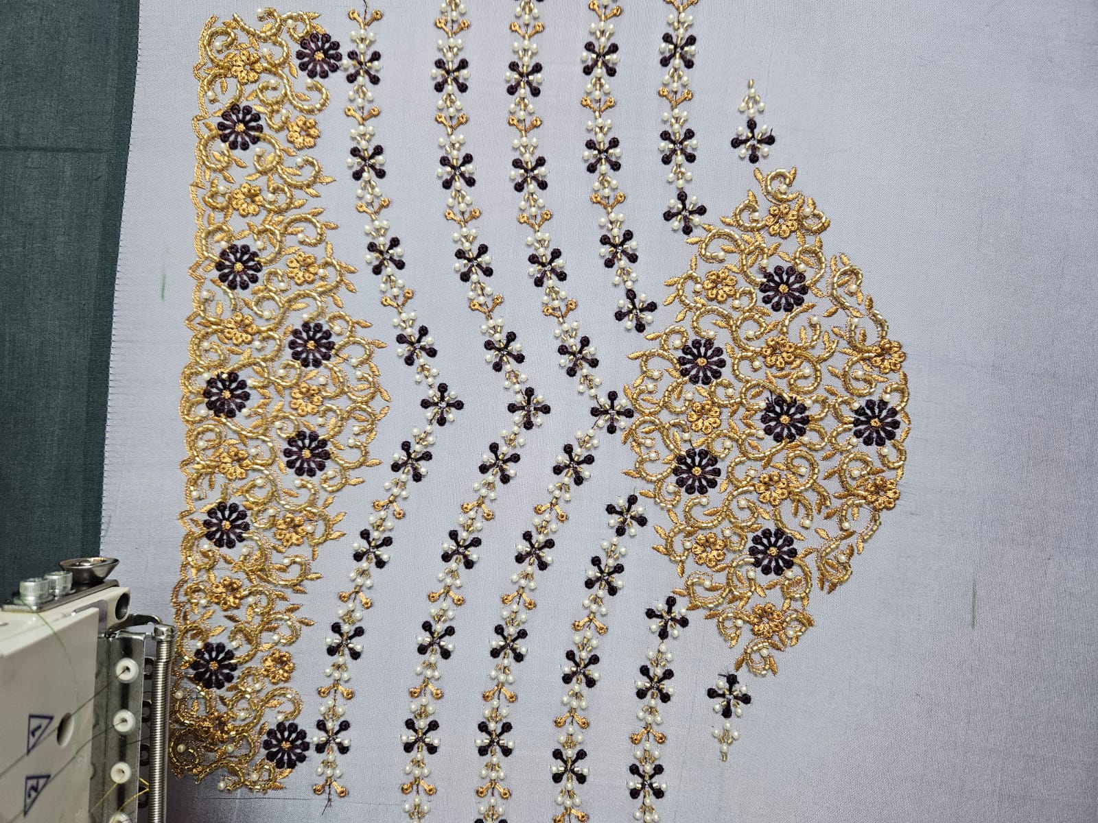 Maroon bridal blouse with intricate gold Maggam embroidery
